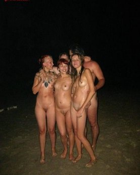 Slender nudists bathing naked on the beach