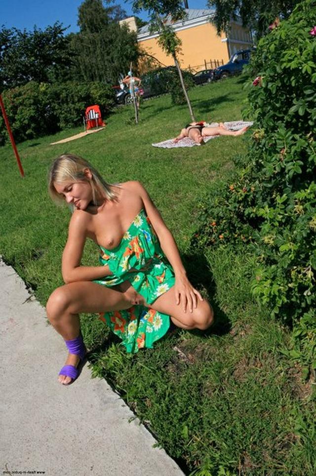 Blonde exhibitionist shows her shaved pussy outdoors 22 photo