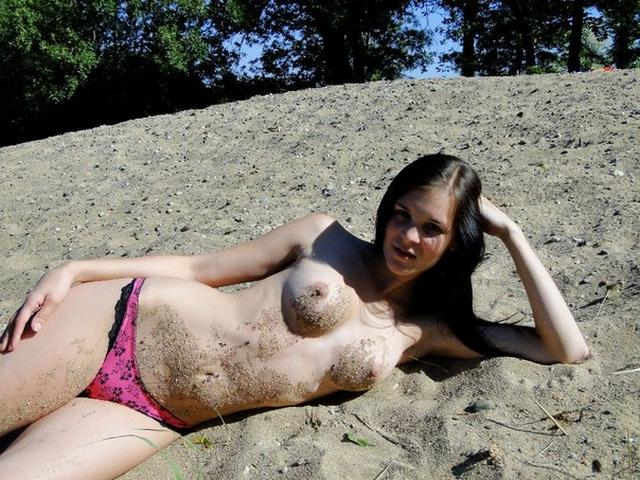 Naked brunette basking on warm sand 15 photo
