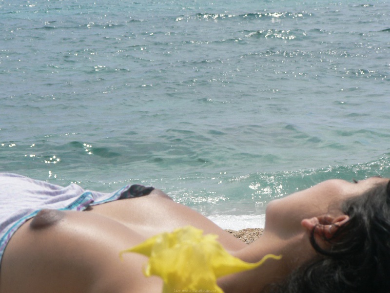 Pregnant with girlfriend relaxing topless on the beach 8 photo