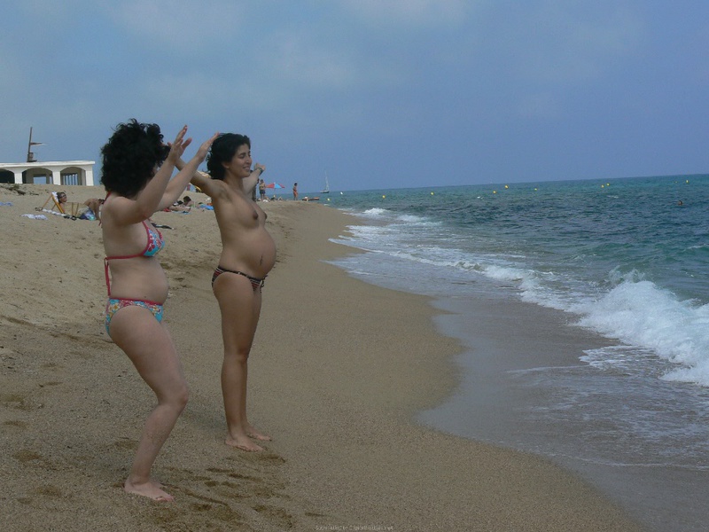 Pregnant with girlfriend relaxing topless on the beach 13 photo
