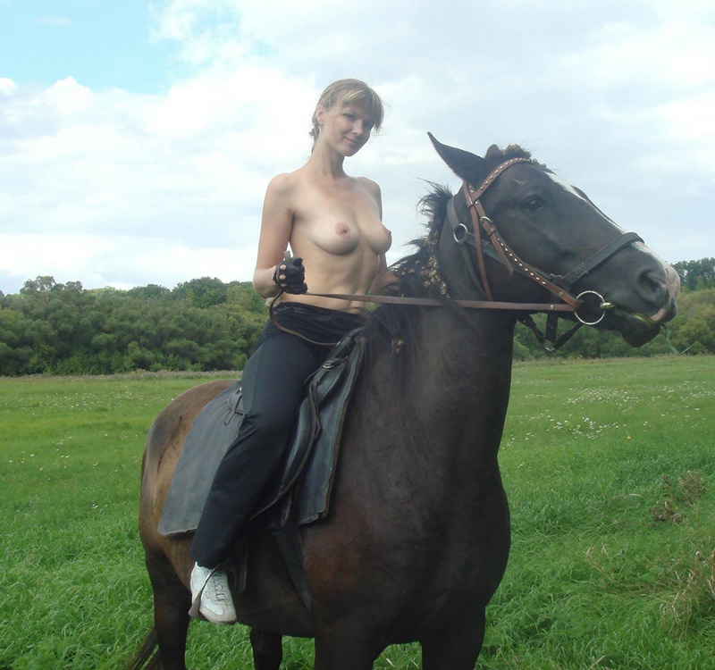 Girl posing topless on a horse among the field 10 photo
