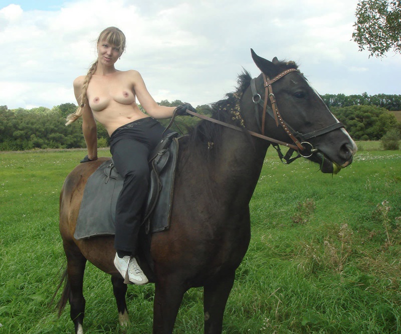 Girl posing topless on a horse among the field 15 photo