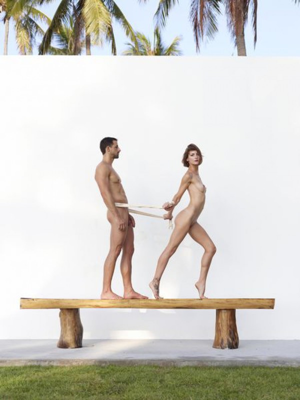 Beautiful couple posing nude on the big wooden bench 15 photo