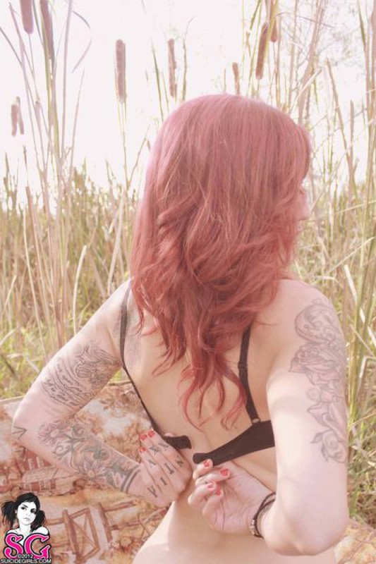 Redhead lusty babe in a tattoo posing on country meadow 37 photo