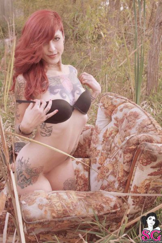 Redhead lusty babe in a tattoo posing on country meadow 30 photo