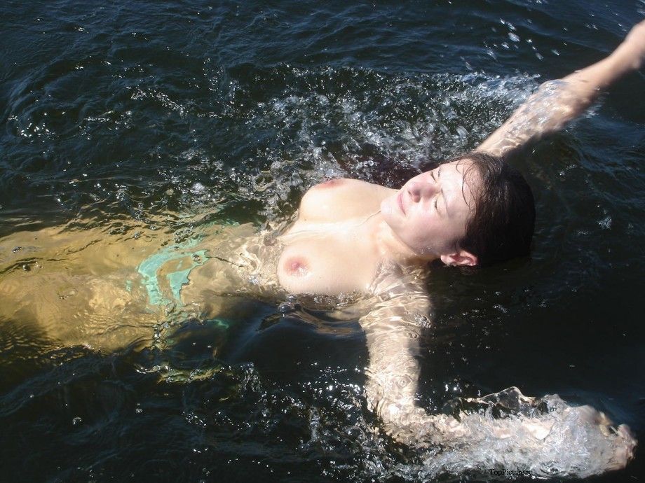 Girlfriend with big boobs rides on the river on a boat topless 5 photo