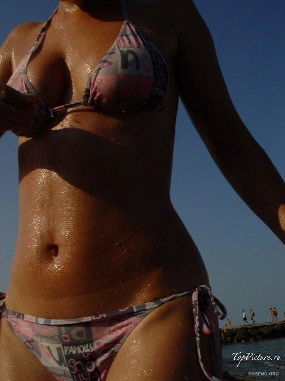 Girls sunbathing and swimming topless on the beach 13 photo